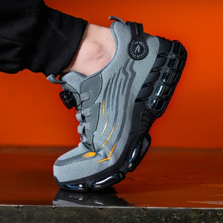 Detail van de snelle draaisluiting op grijze heren werkschoenen voor optimale pasvorm en voetbescherming.