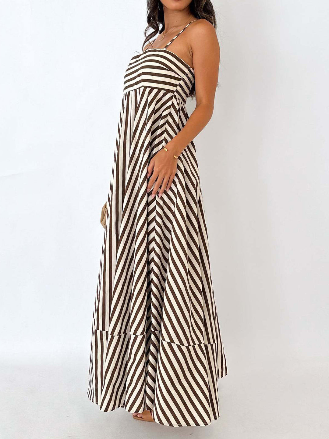Mouwloze lichtbruine dames maxi jurk met gestreept plissé patroon, elegant en comfortabel voor zonnige dagen.