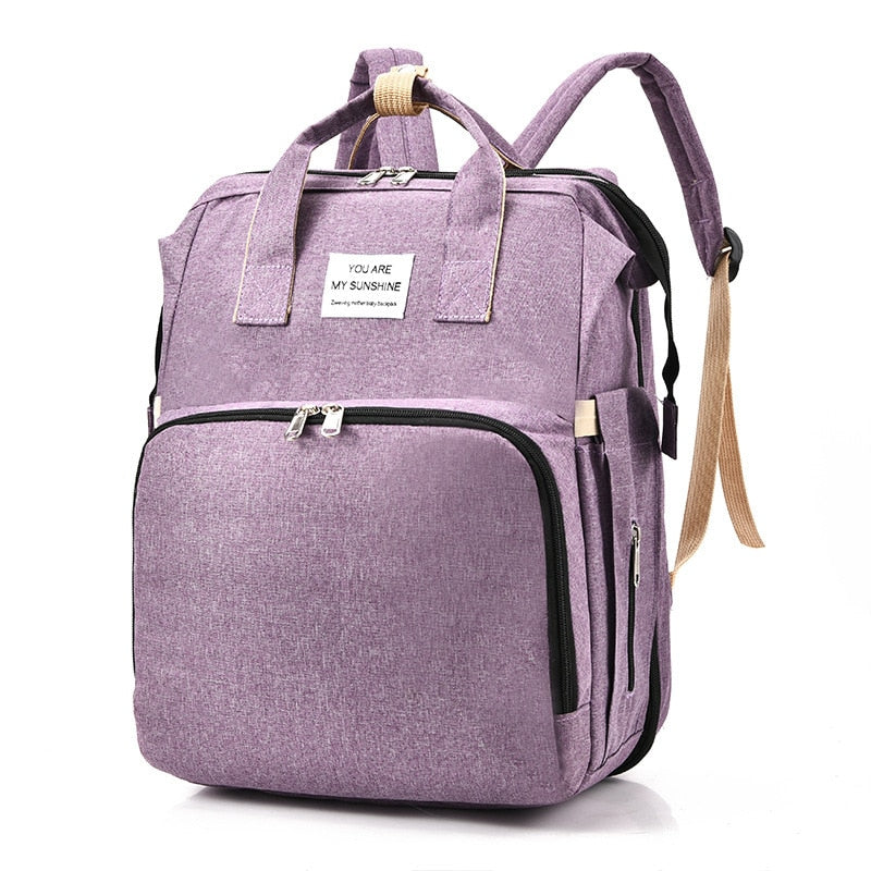 Waterdichte reisrugzak en luiertas met ingebouwd babybedje; essentieel voor ouders met baby.