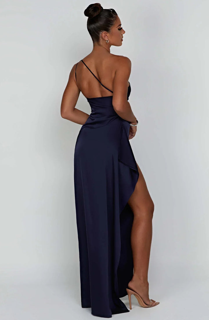 Lichtbeige feestjurk met one shoulder, fijne plooien en een lange split.