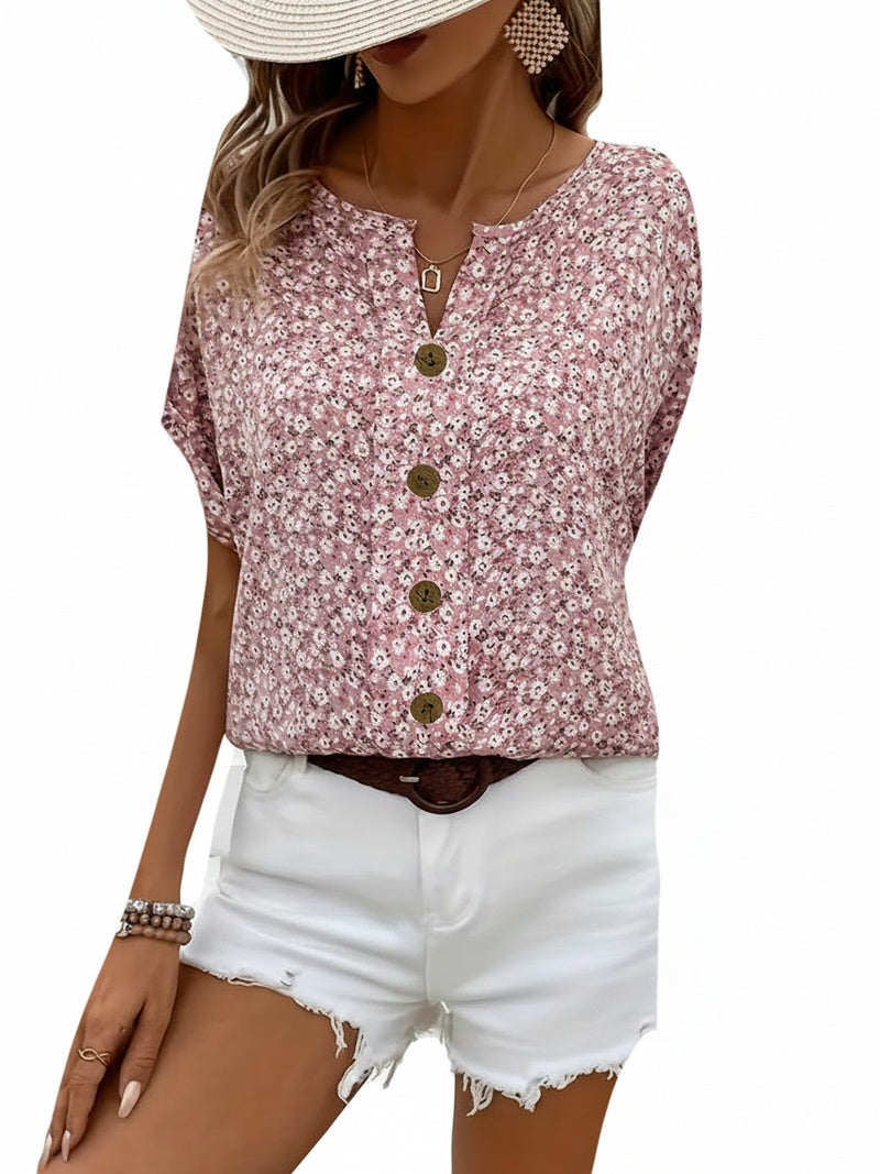Roze dames zomerblouse met delicate bloemenprint en comfortabele knoopsluiting, perfect voor casual dagen.