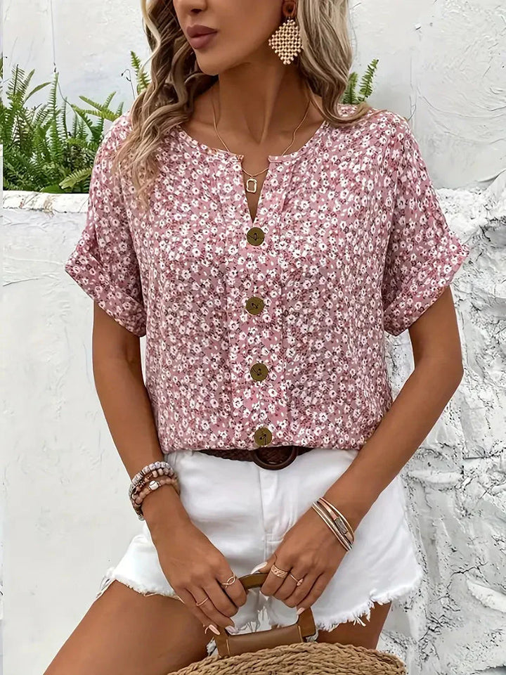 Frisse dames zomerkleding: roze blouse met levendige bloemenprint, korte mouwen en comfortabele pasvorm.