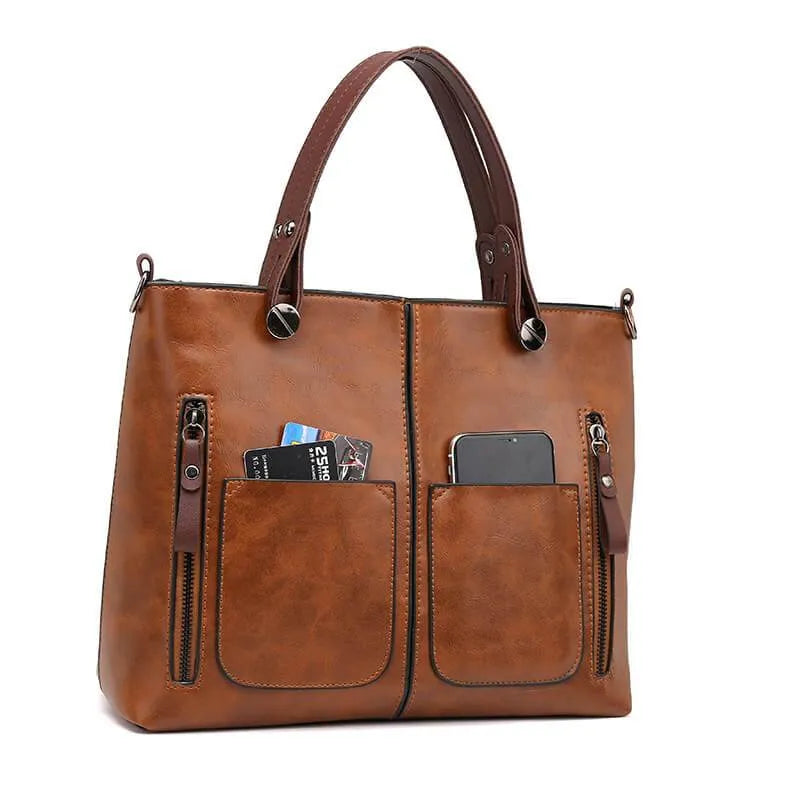 Bruine leren schoudertas voor dames, elegant accessoire voor werk of vrije tijd.