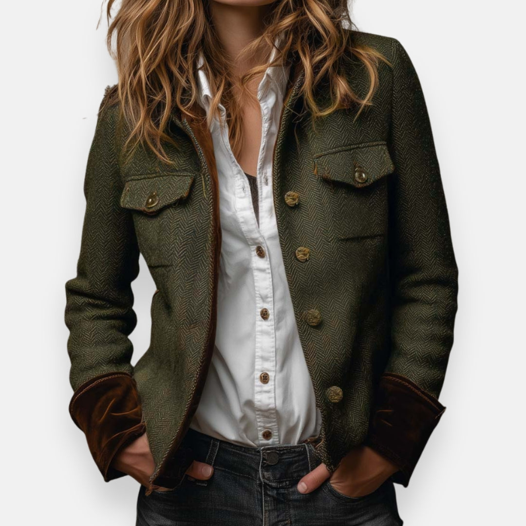 Stijlvolle donkergroene dames visgraat blazer met contrasterende manchetten, perfect voor een elegante look.