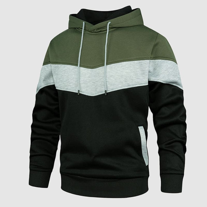 Model draagt een trendy heren hoodie met capuchon en kleurblokken, perfect als herfstkleding.