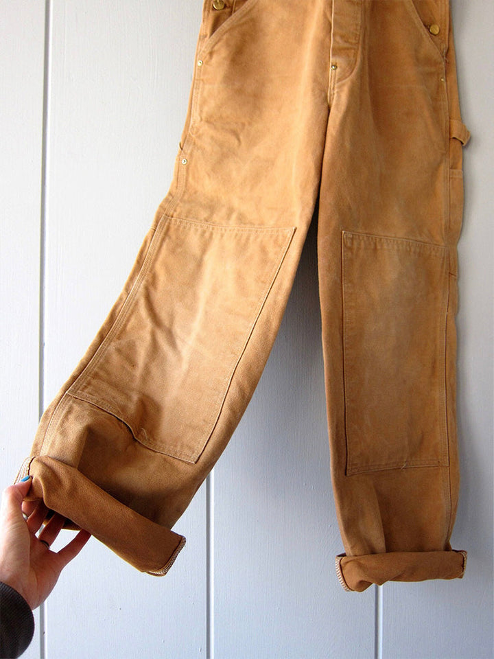 Unisex canvas werkoverall met ruime borstzak en zijzakken, ideaal voor het opbergen van gereedschap.