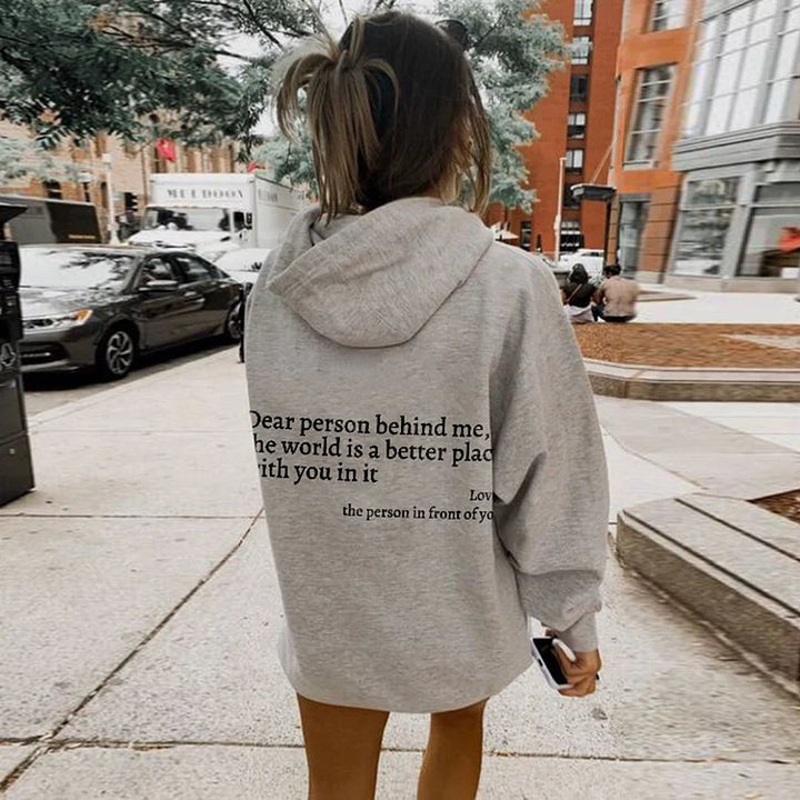 Witte unisex hoodie met 'Lieve Persoon Achter Mij' tekst. Verspreid vriendelijkheid met deze comfortabele trui.