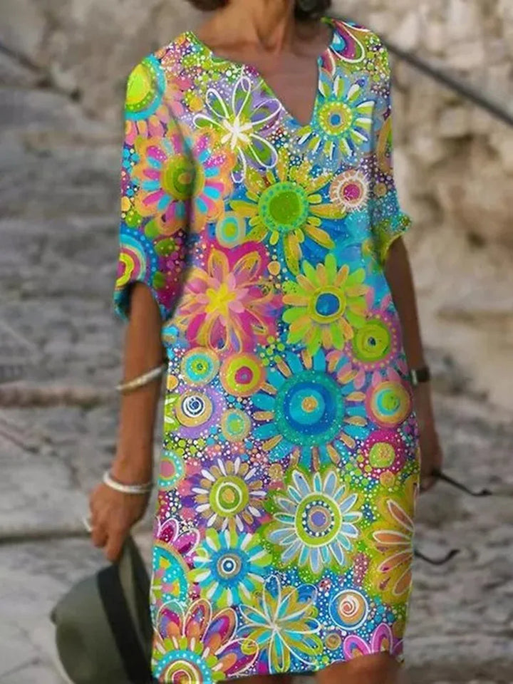 "Vrouwelijke boho jurk met levendige bloemenprint, elegante V-hals en vloeiende stof, ideaal voor stijlvolle zomerdagen."