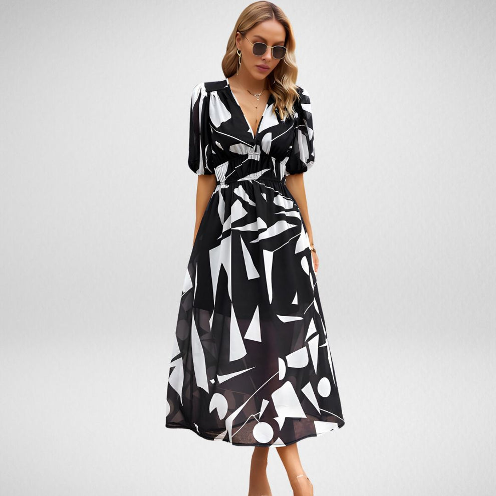 "Zomerse midi-jurk met vrolijke prints en pofmouwen, perfect voor zonnige dagen. Luchtige stof, elastische tailleband."