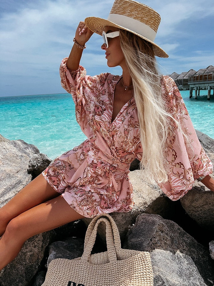 "Zomerse playsuit met V-hals, fruit- en bladmotieven, kleurrijke tropische print, accentueert silhouet en biedt comfort."