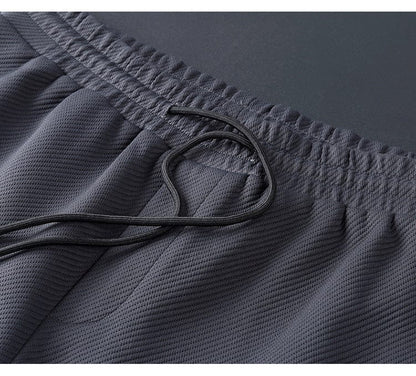 "Zwart heren loungepak van lycra, comfortabel en stijlvol voor dagelijks gebruik in vrije tijd of sportactiviteiten."